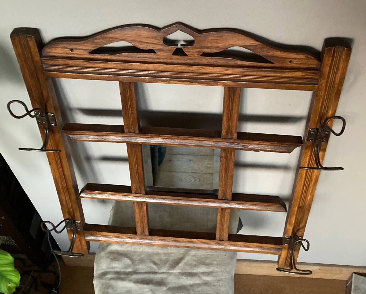 Art Deco wall-mounted coat rack in oak, early 20th century. Beveled central mirror