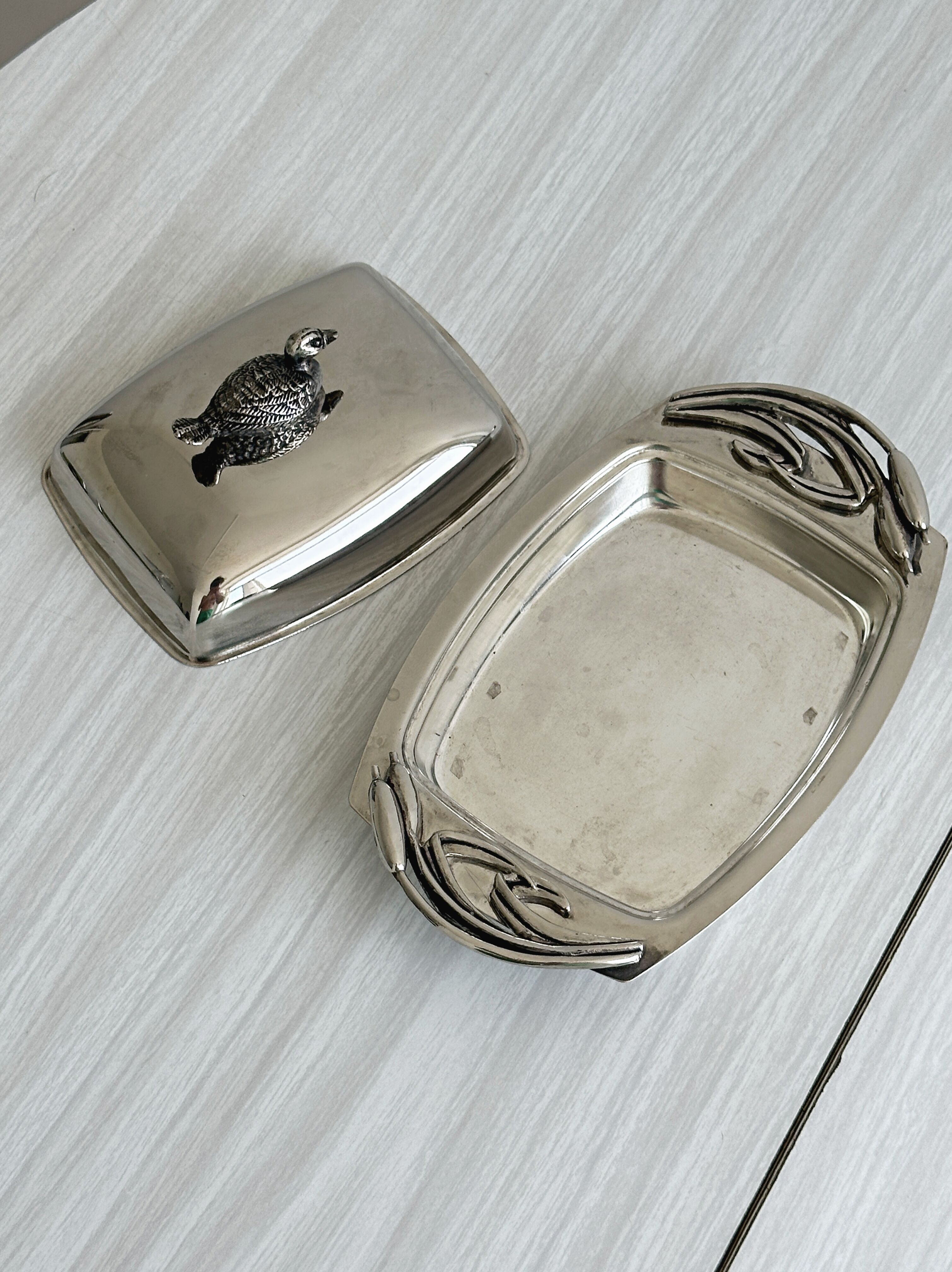 Antique shiny metal butter dish