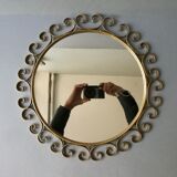 Round mirror with golden metal arabesques