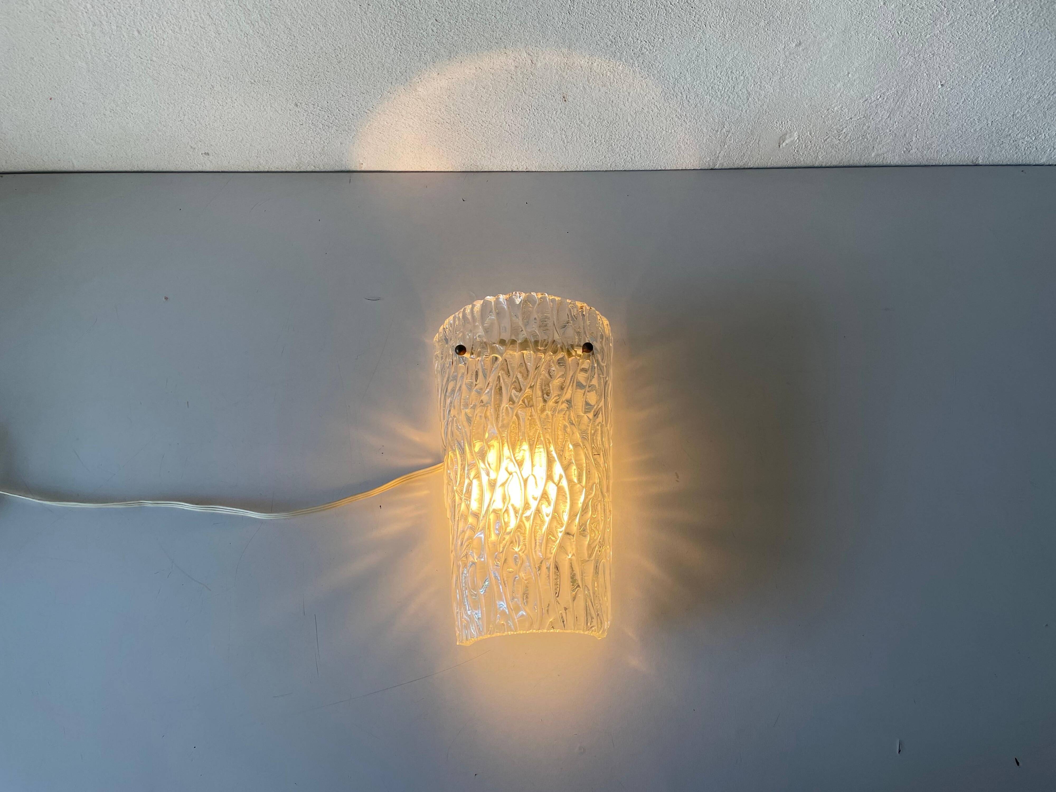 Simple arch-shaped wall light in textured glass, 1950s, Germany.