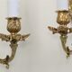 Pair of louis XV beveled mirror wall lamps in bronze by "Lucien Gau"
