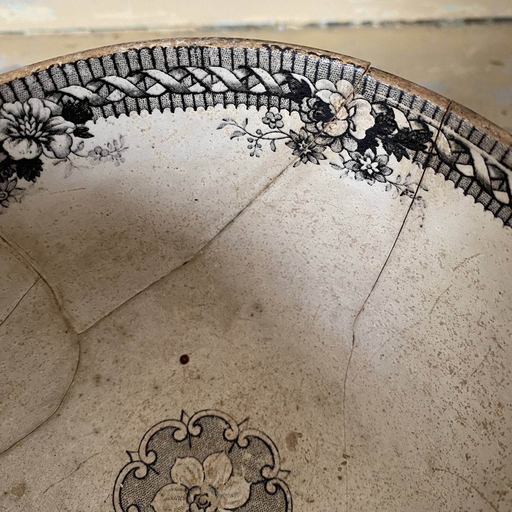 Old bowl made of iron with ceramic seams.