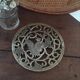 Underneath the brass dish
