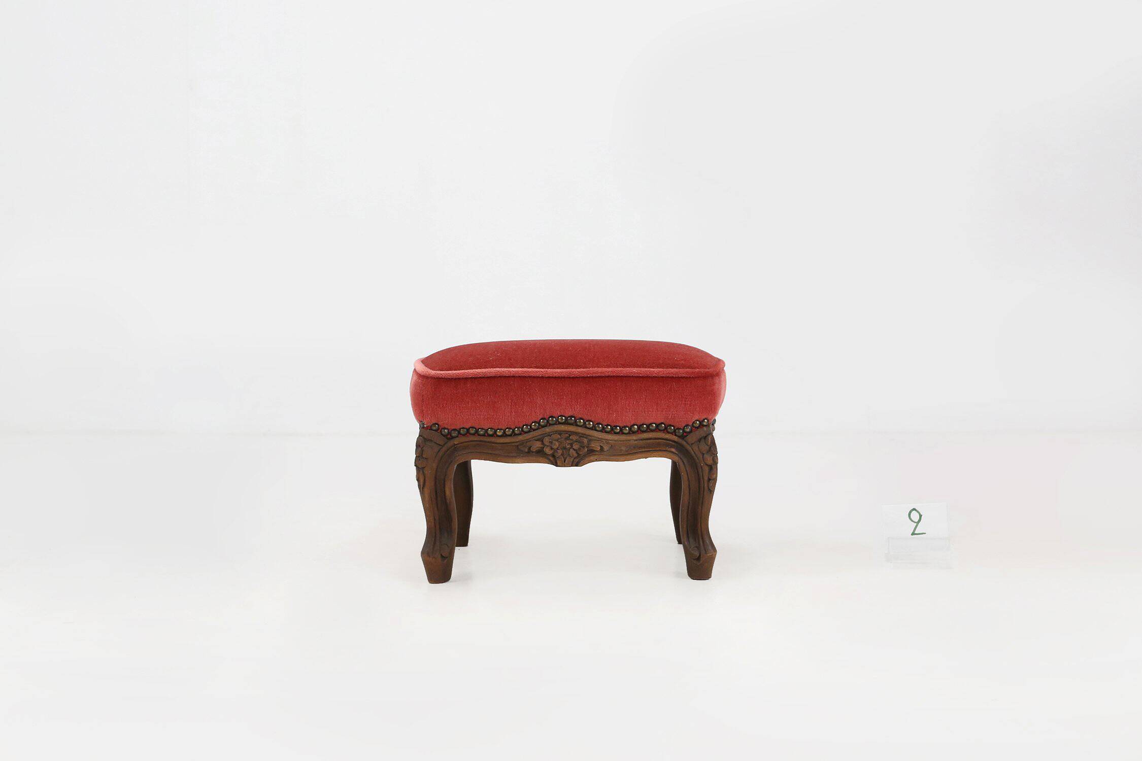 Baroque style foot stool in carved wood with coral velvet upholstery