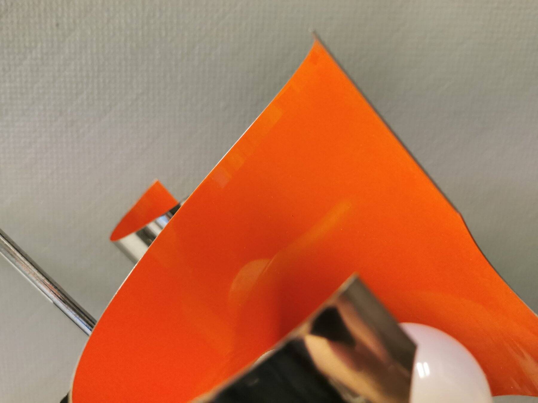 Hanging lamp in chromed metal with orange contrast lacquer and three light sources.