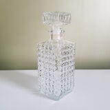 A square glass whiskey decanter