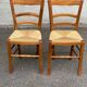 2 wooden dining chairs with rush seats from the 1970s.