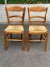 2 wooden dining chairs with rush seats from the 1970s.
