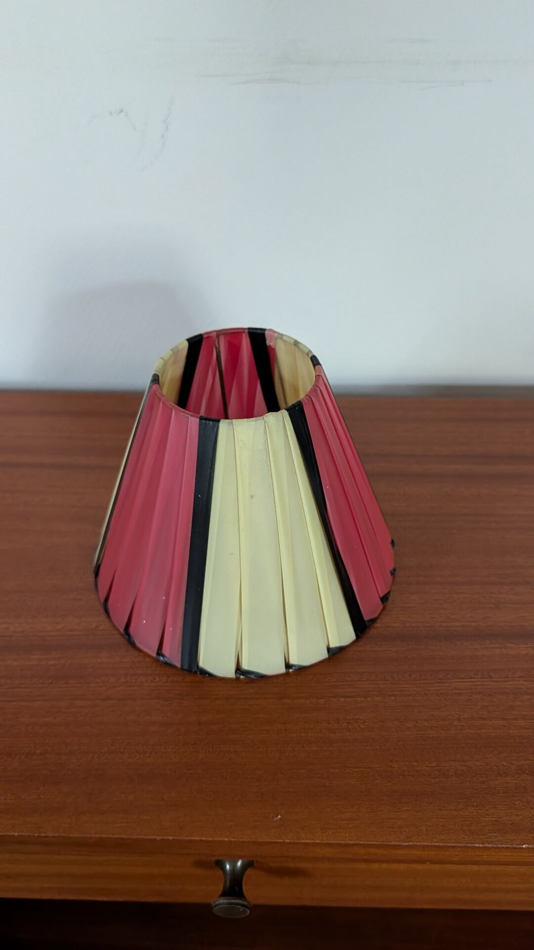 Pleated red and pale yellow plastic conical lampshade from the 1960s.