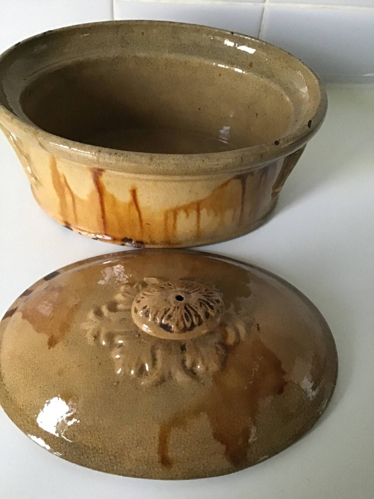 Old terrine of pastry or foie gras in beige glazed earthenware with brown drips. Very beautiful pa