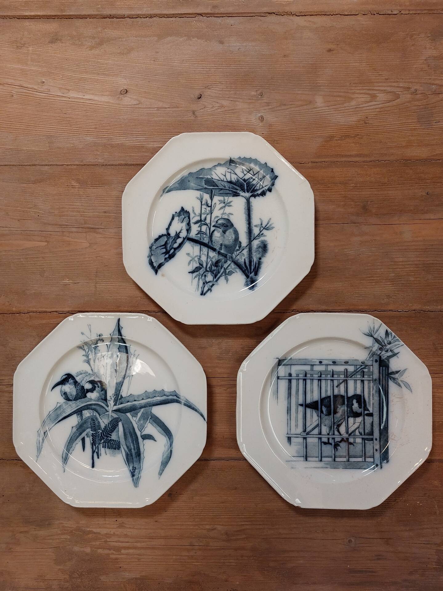 Set of three ironstone plates decorated with birds.