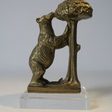 Brass sculpture, bear looking for honey in the tree