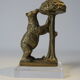 Brass sculpture, bear looking for honey in the tree