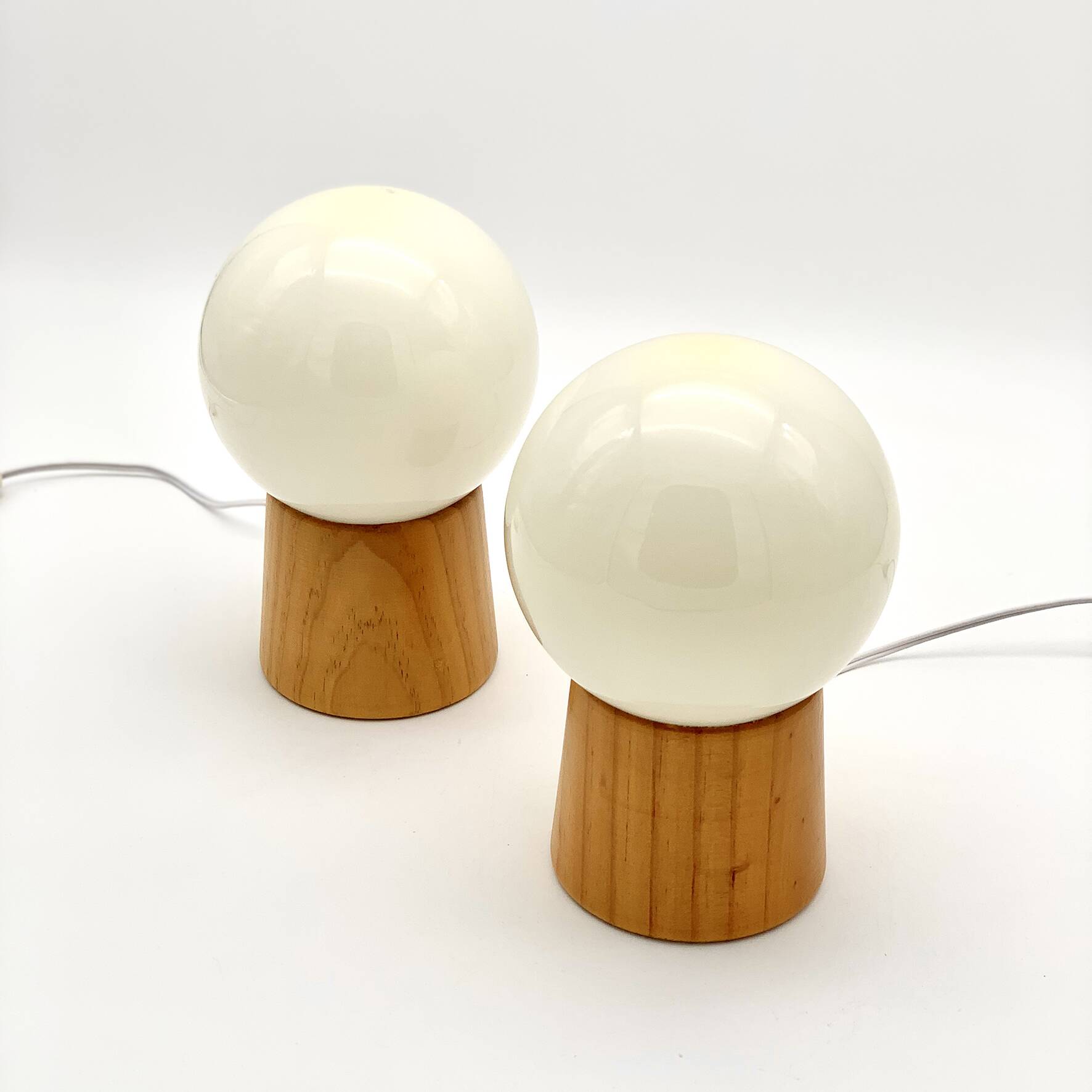 Pair of lamps with wooden base and glass globe, 1970s