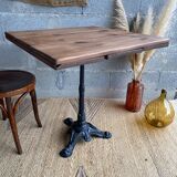 Bistro table with central cast iron leg and rustic top