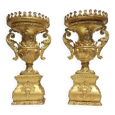 Rare pair of carved and gilded wooden vases, with a refined style inspired by the Empire.
