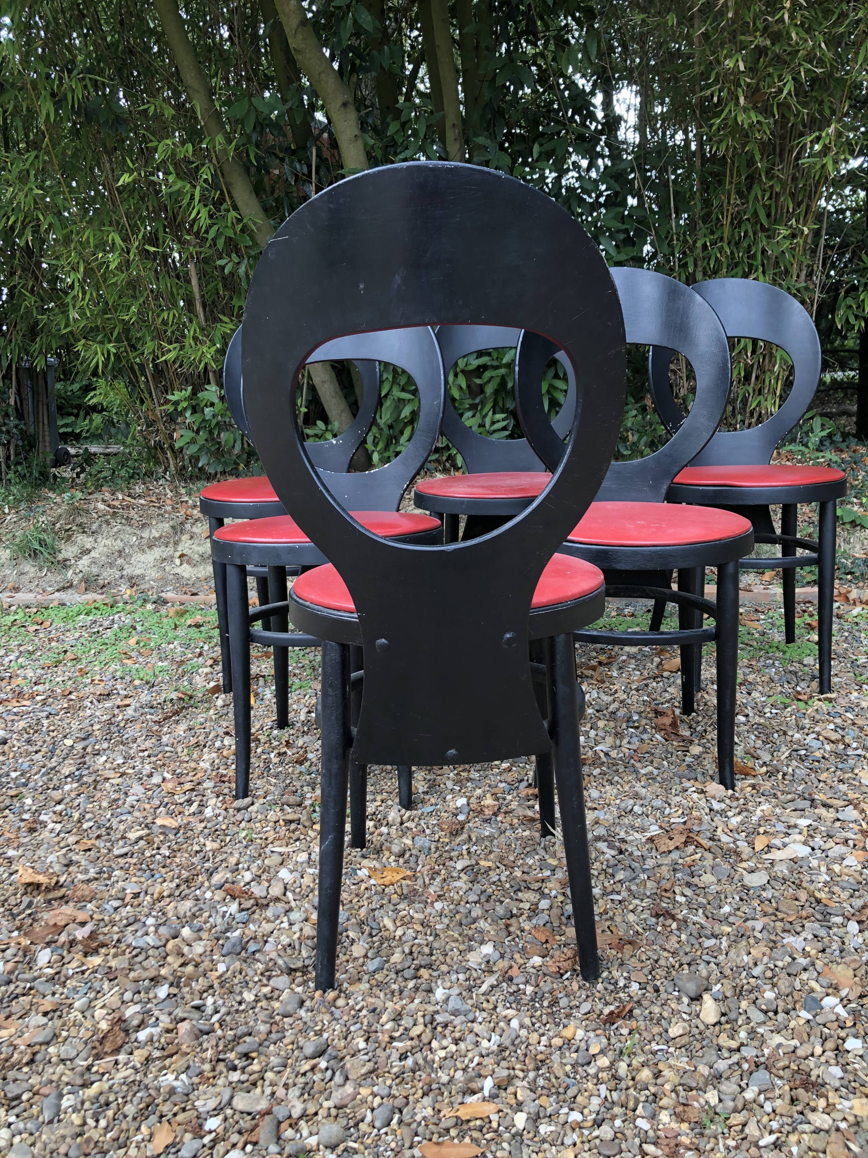 6 vintage Baumann seagull model chairs, black lacquered with red Skai seats.