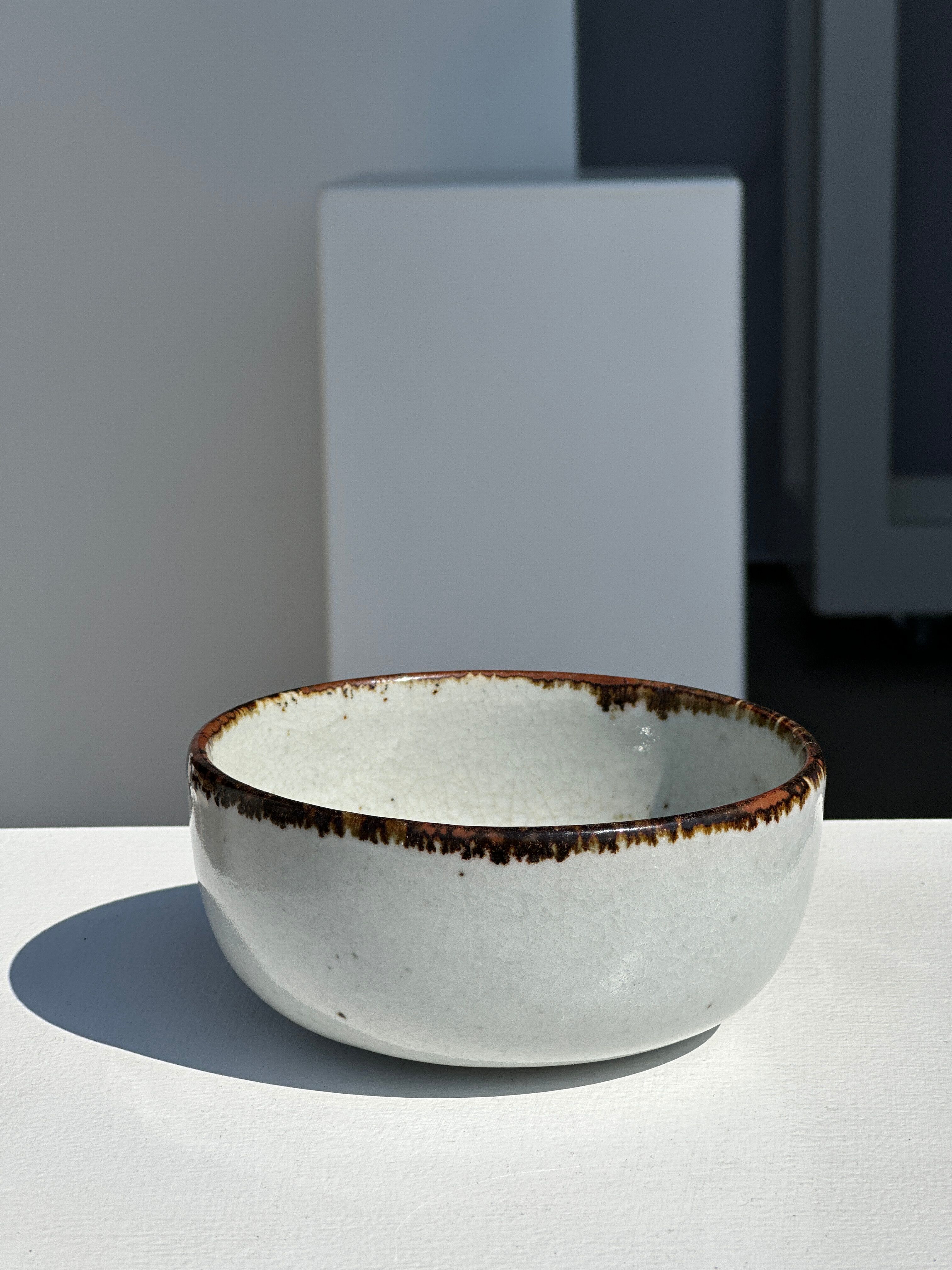 Small white glazed ceramic bowl black edges