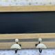 Wall-mounted coat rack with porcelain hooks