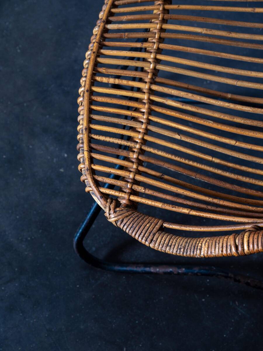 Rattan armchair with metal legs