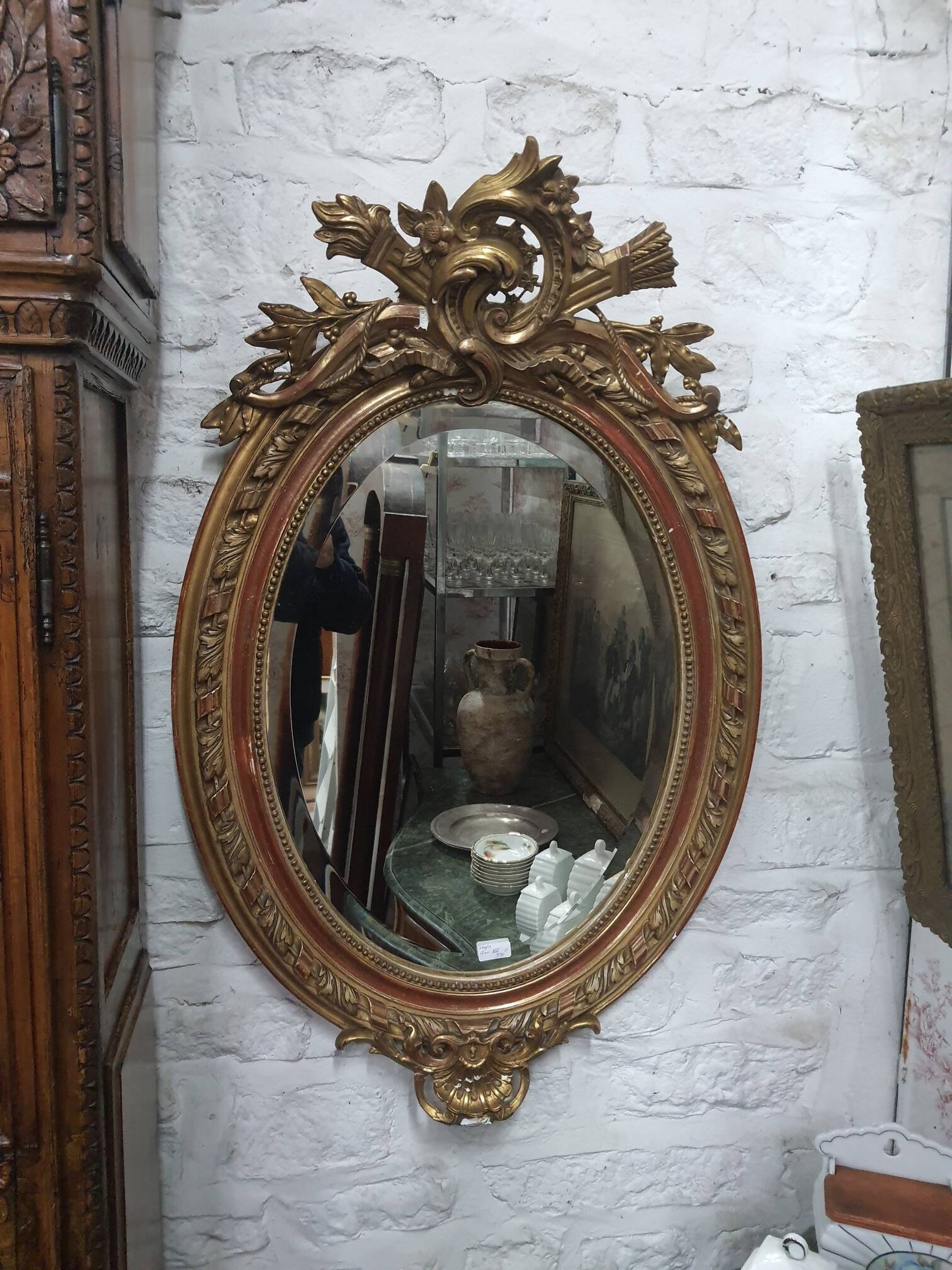 Golden oval mirror