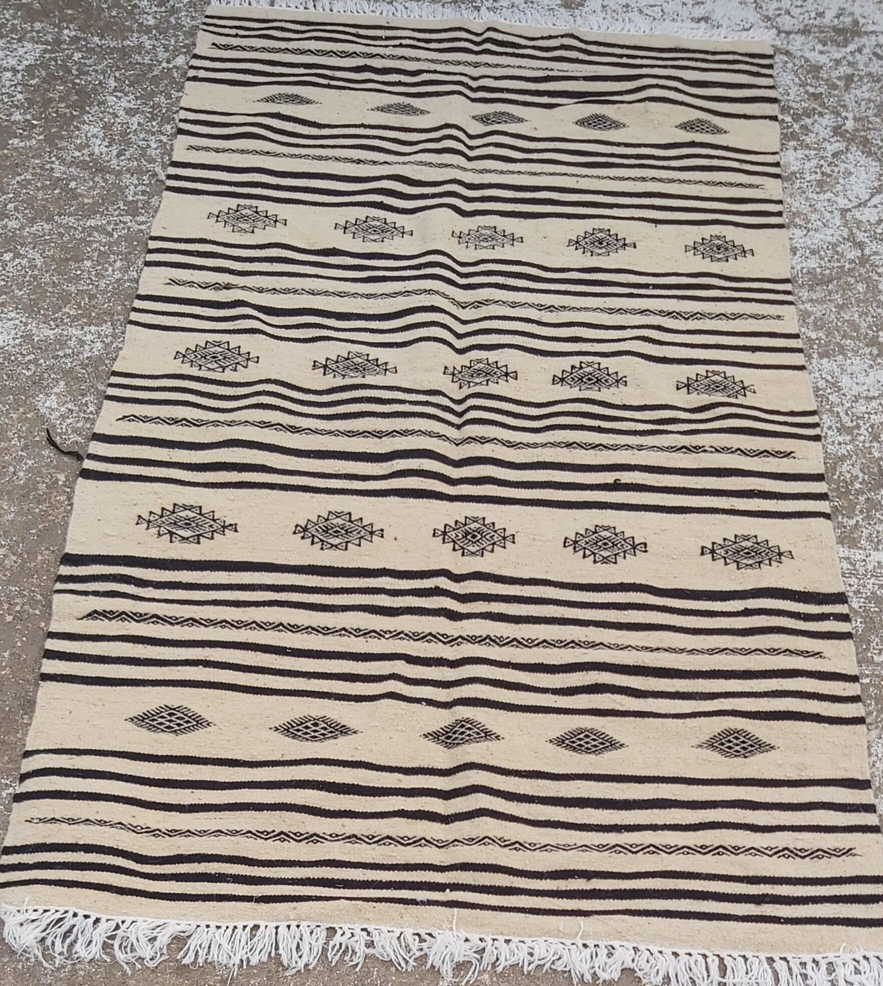 Traditional hand-woven beige and black carpet