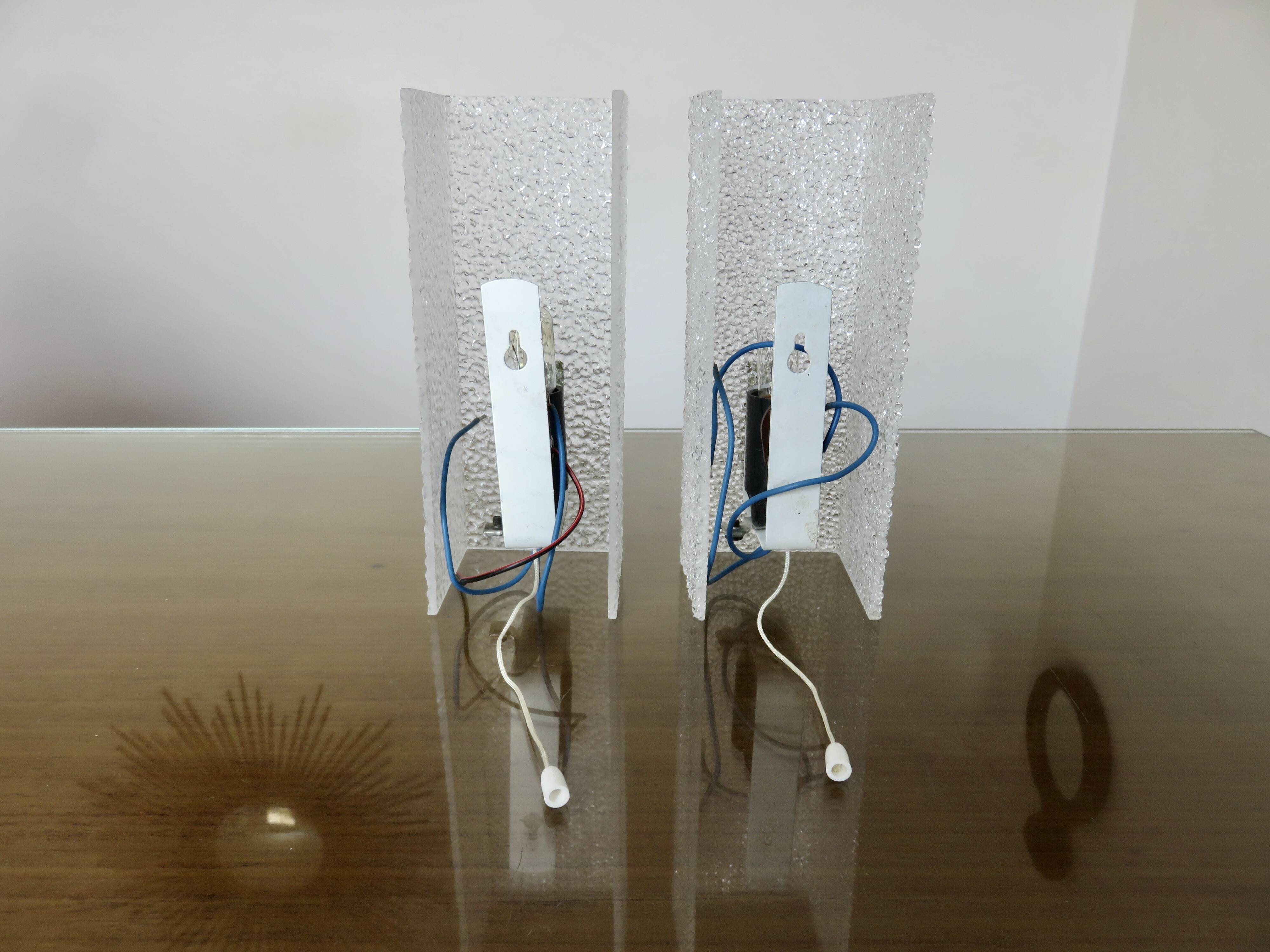 Pair of pull switch wall lights in perspex and gilded brass, France, circa 1960.