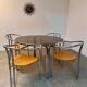 Table ronde vintage tubulaire en métal et verre fumé design année 70