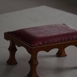 Danish sculpted oak stool from the mid-20th century with a red leather seat, 1950s.