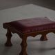 Danish sculpted oak stool from the mid-20th century with a red leather seat, 1950s.