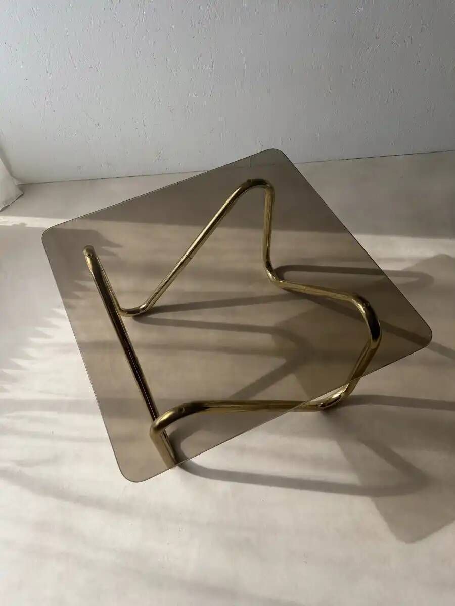 Coffee table with smoked glass and curved metal base