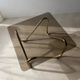 Coffee table with smoked glass and curved metal base
