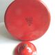 Old vintage kettle in red enamelled sheet metal, with white polka dots
