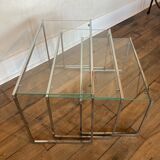 Modernist work, suite of three trundle tables in chromed metal and glass