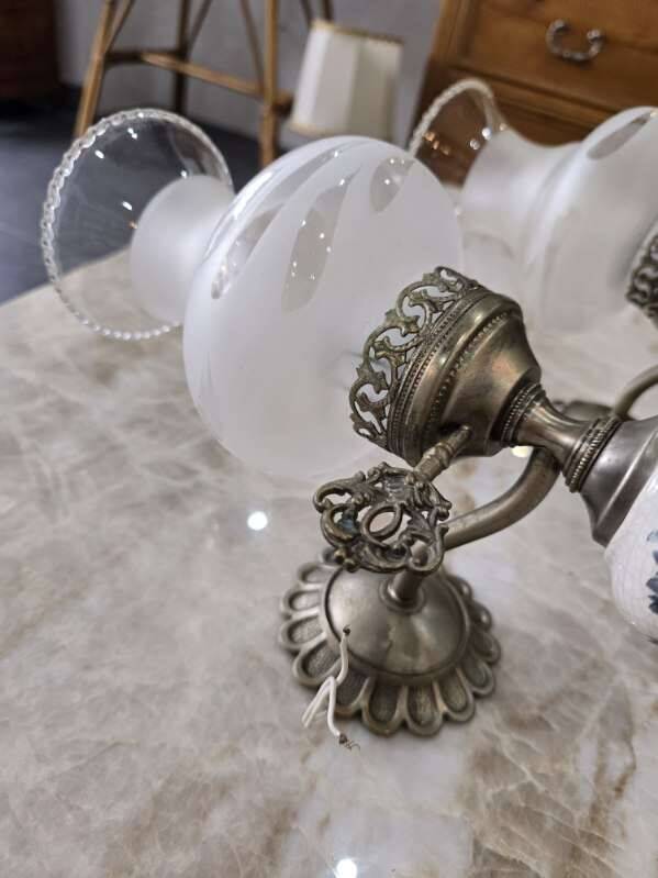 Pair of vintage wall sconces in brass, porcelain, and frosted glass.