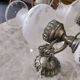 Pair of vintage wall sconces in brass, porcelain, and frosted glass.