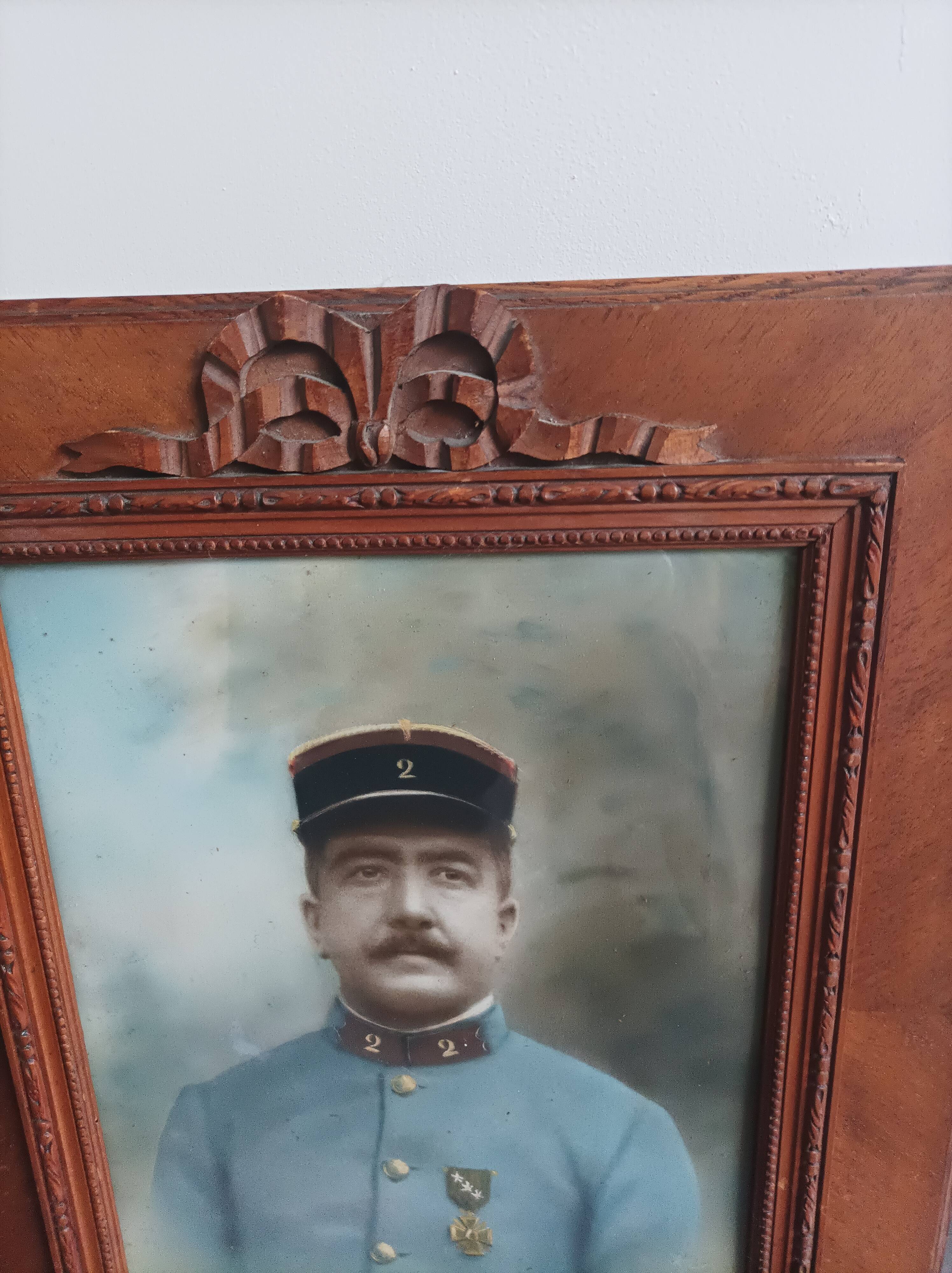 Antique wooden frame with carved portrait knot