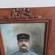 Antique wooden frame with carved portrait knot