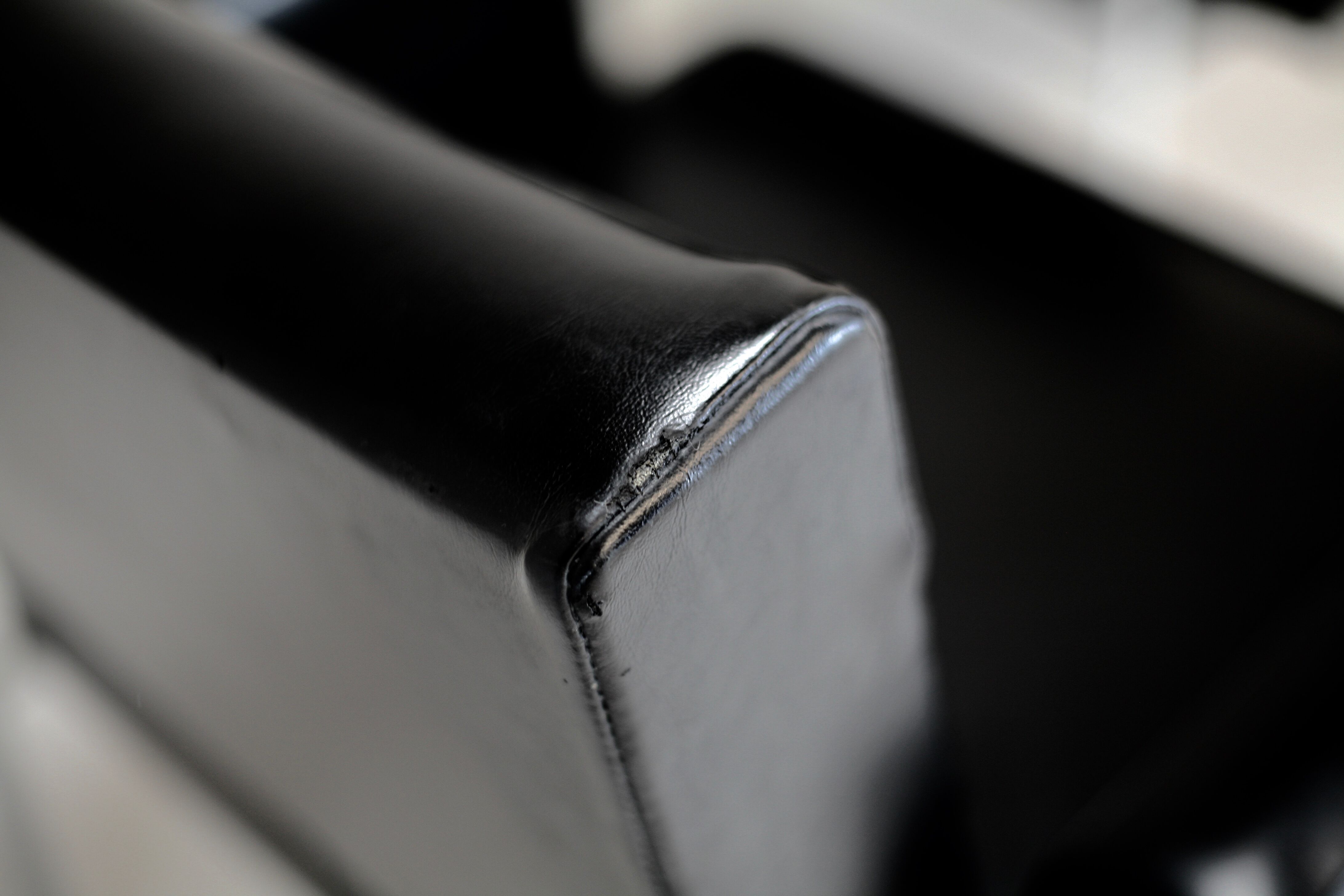 Pair of stainless steel, black leather-like armchairs, France, circa 1970