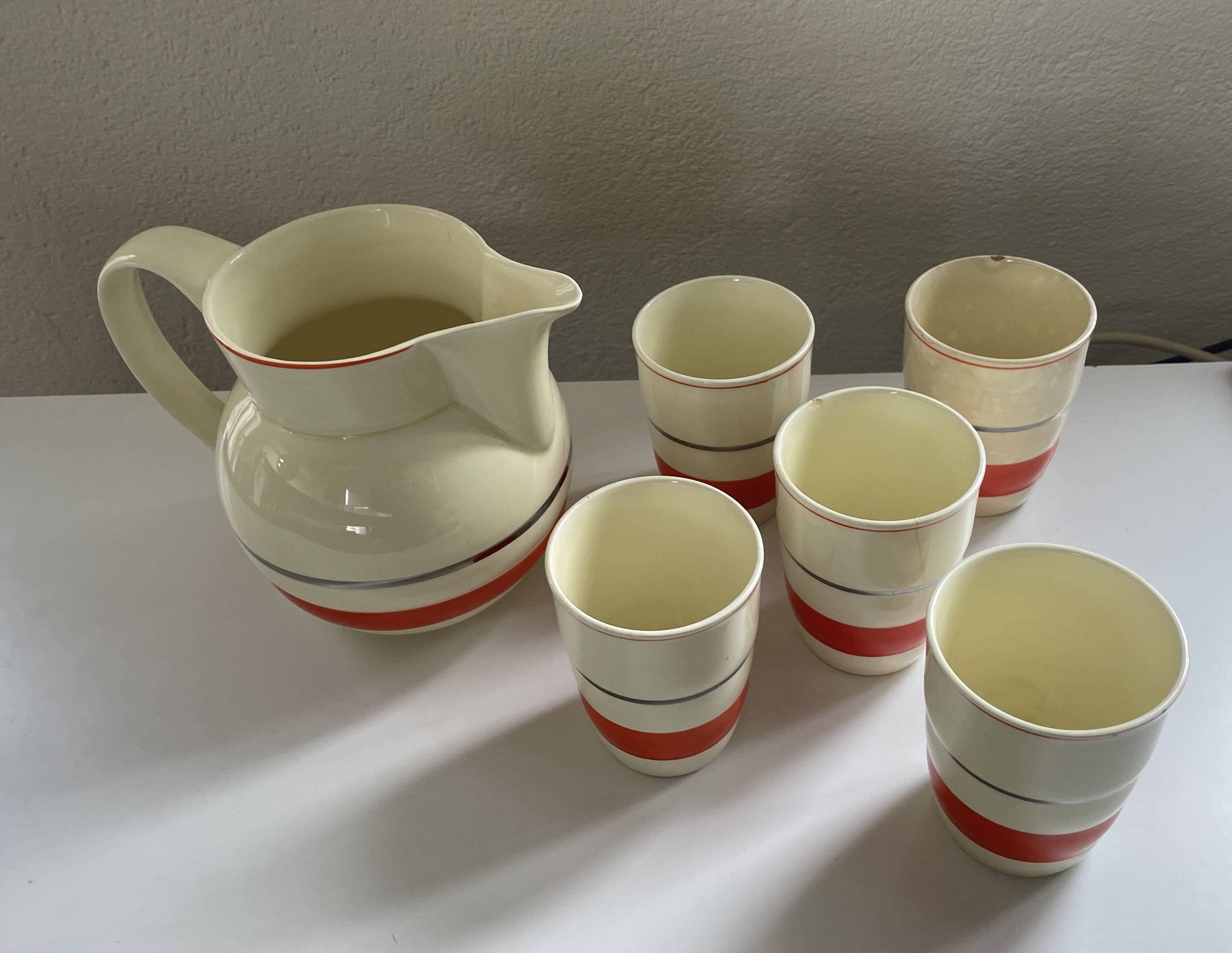 Red, white and silver porcelain jug set by Edmond Bellefroid for Robo.