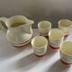 Red, white and silver porcelain jug set by Edmond Bellefroid for Robo.