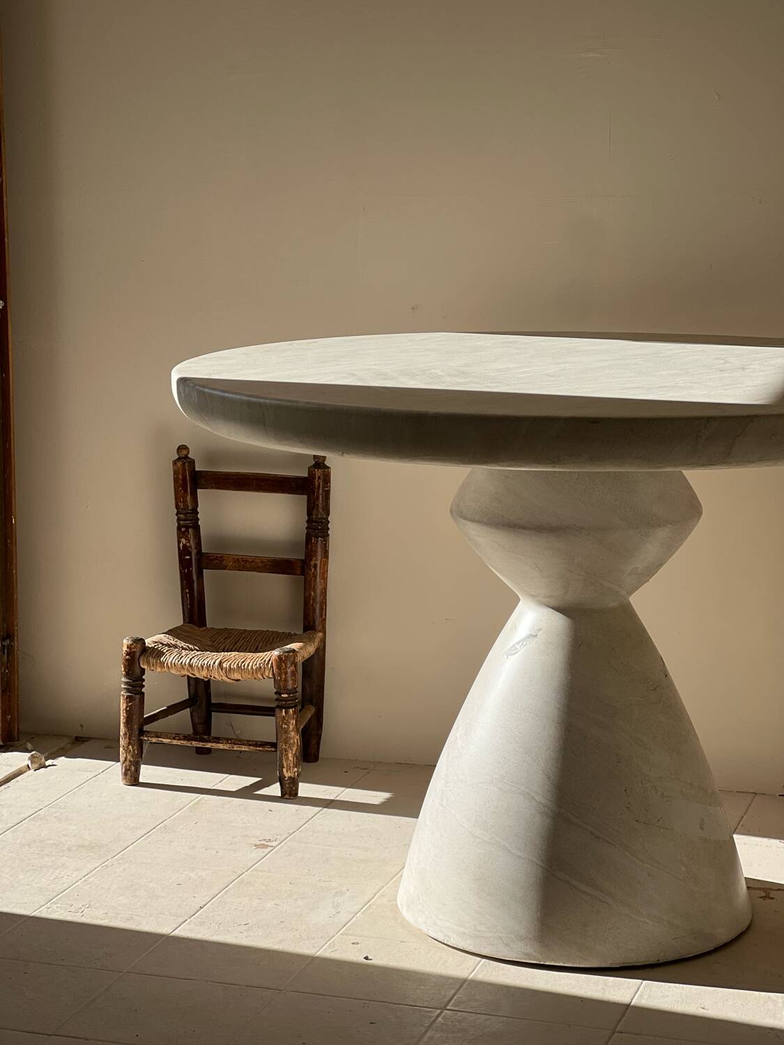 Travertine-effect stone dining table