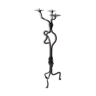 Large wrought iron candelabrum with an abstract design and three candle holders.