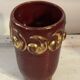 Mid-century relief vase in ruby red enhanced with gilding.