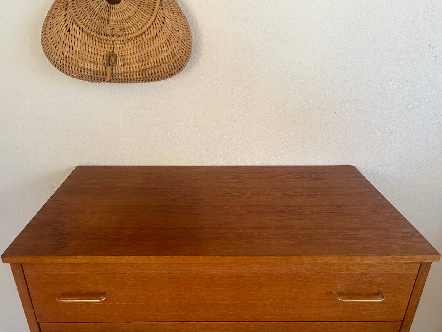Vintage 1960s chest of drawers with covered handles.