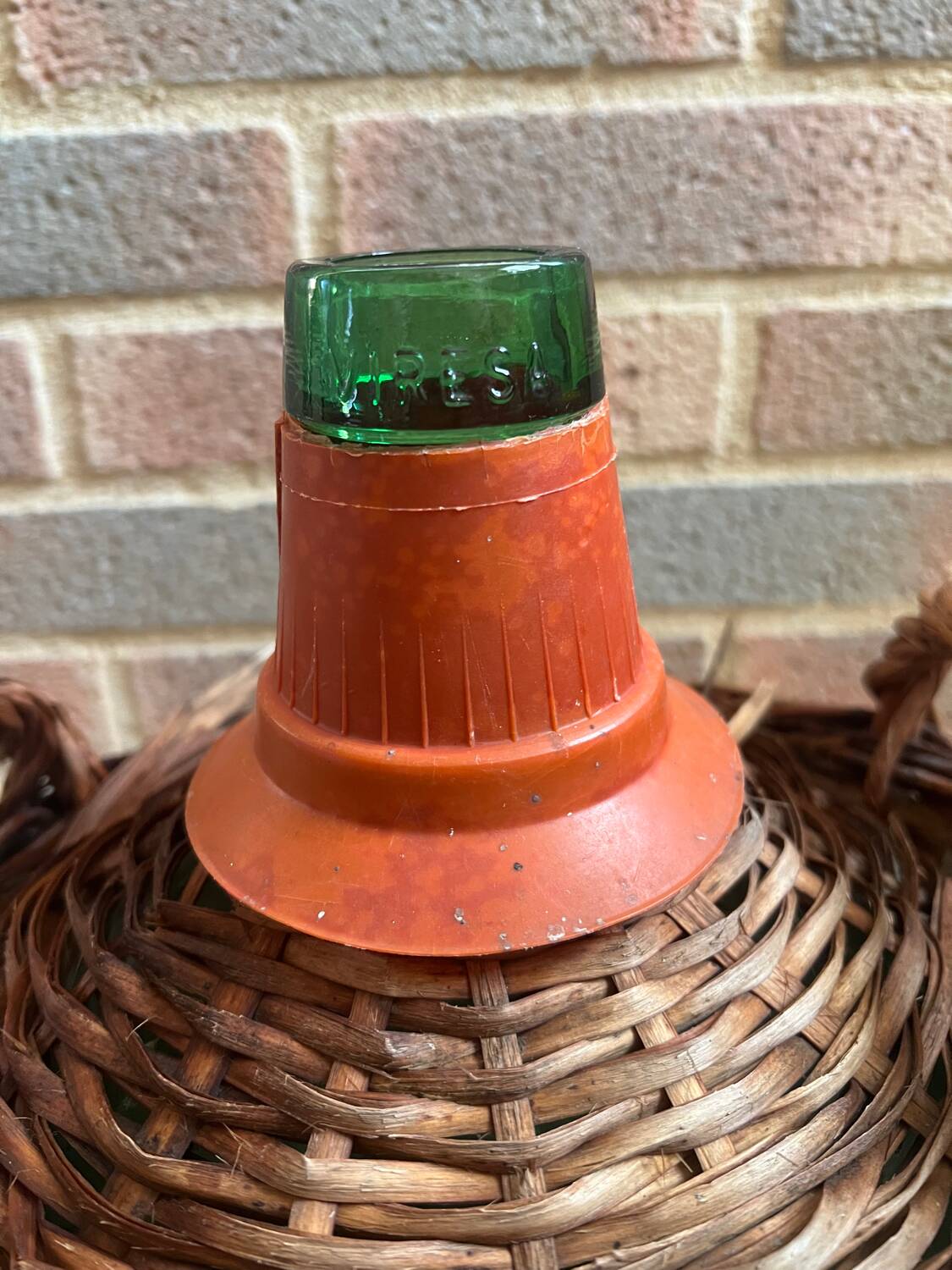 Old glass demijohn with wicker basket.