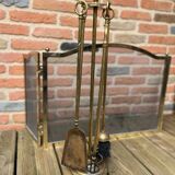 Old brass fireplace set and its fire screen grille