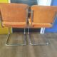 Pair of vintage cantilever chairs in chrome and orange corduroy.