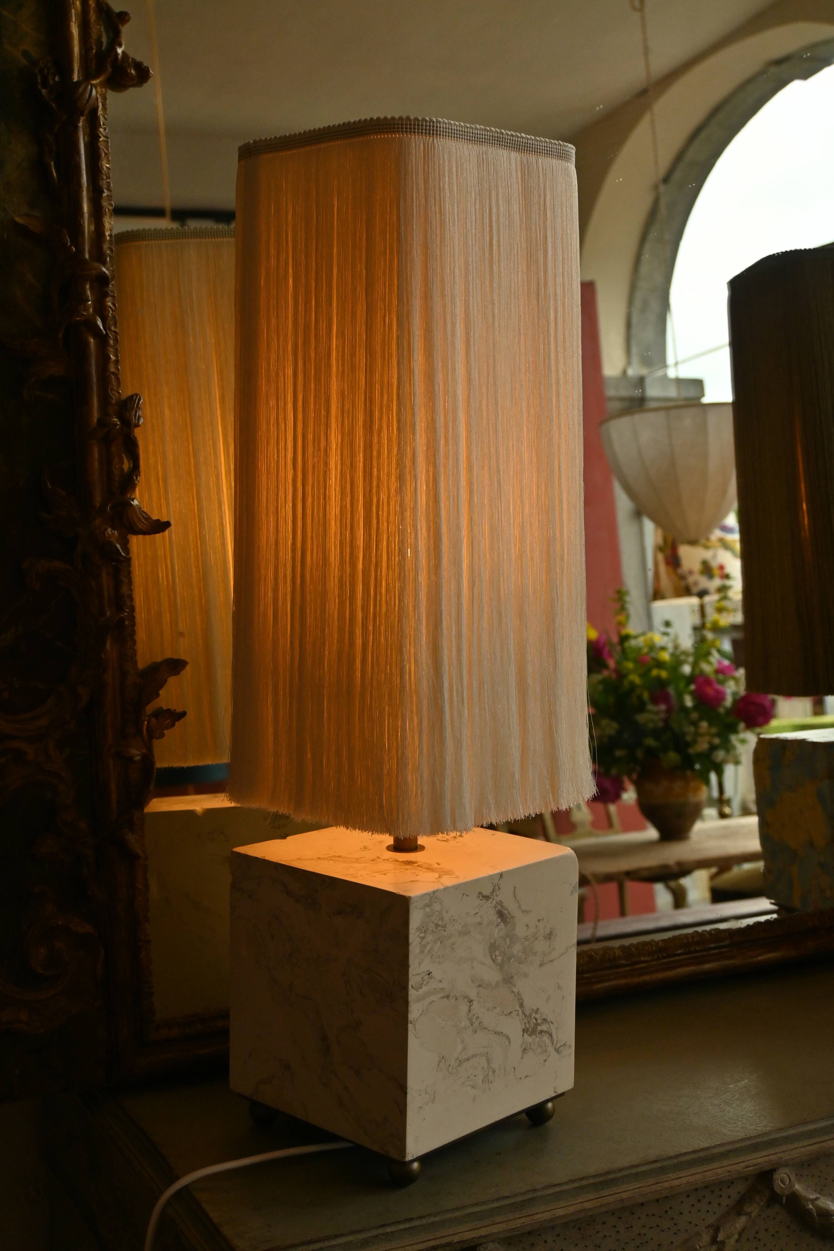 Beige marble stucco base, Houles white ecru fringed lampshade.