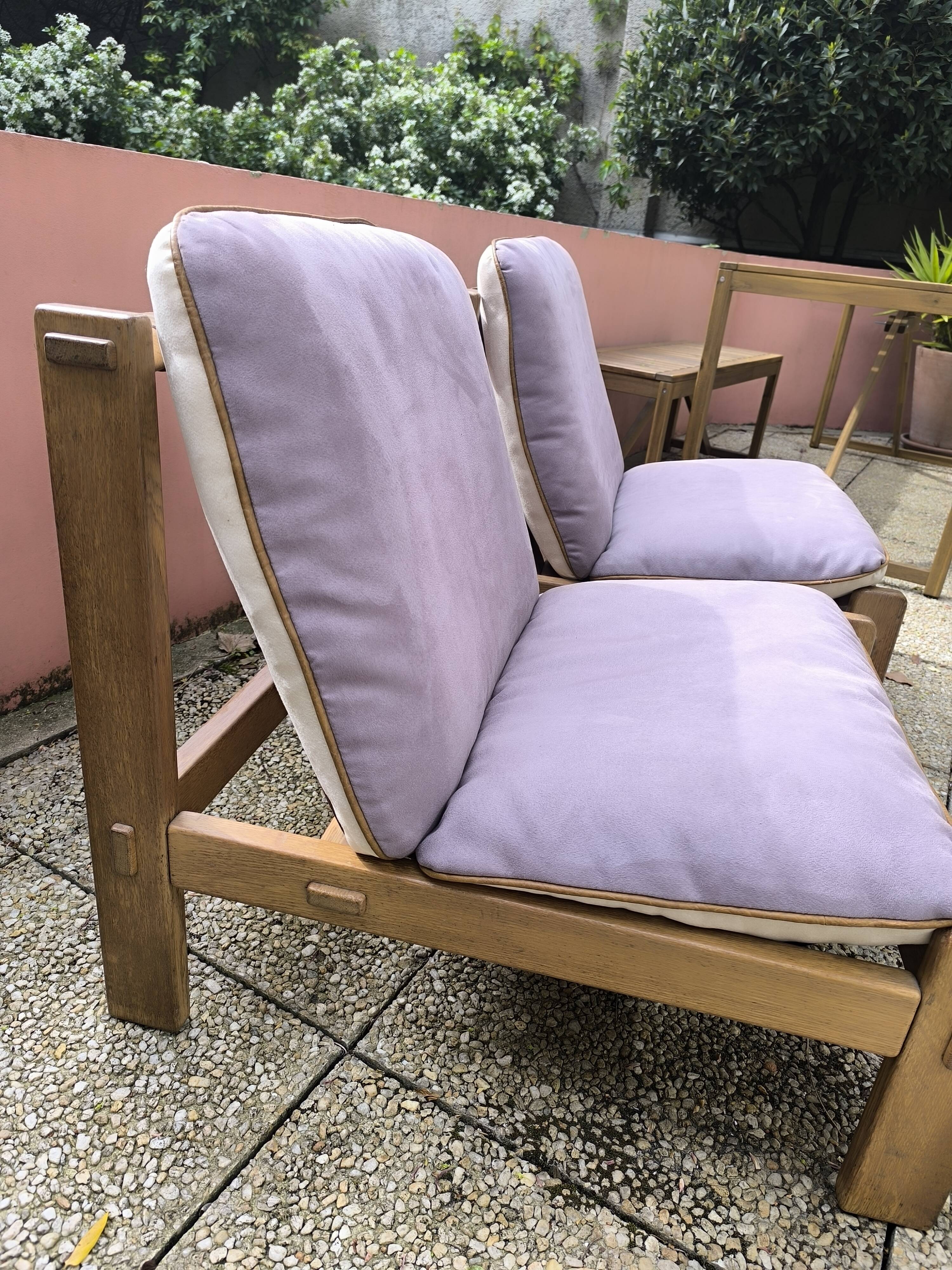 Pair of solid wood and leather lounge chairs, European work, circa 1970.